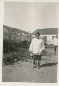Image: Eskimo [Inuk] man holding clock
